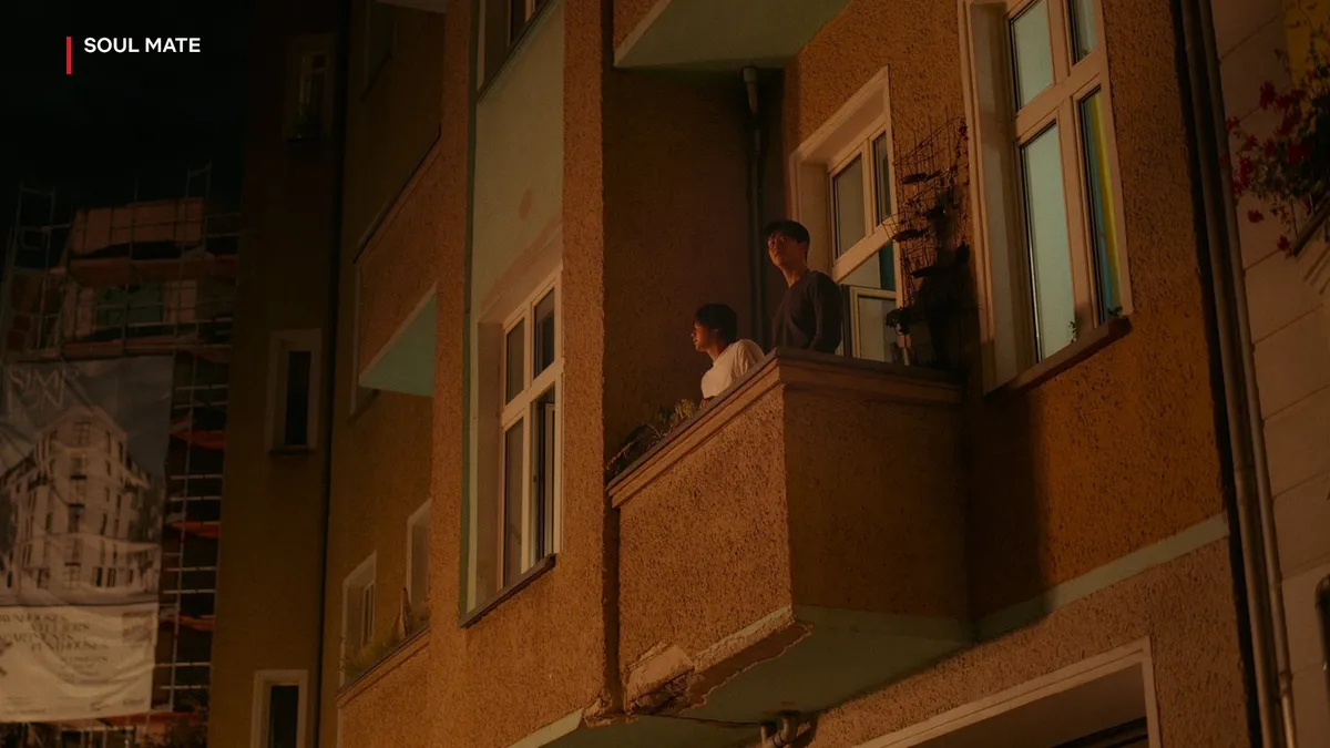 Ryu and Hwang standing on an apartment balcony at night in Soul Mate